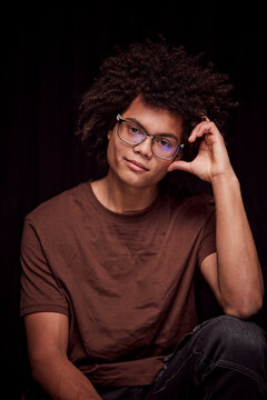 Studio portrait of young colored man with glasses on. Munich, Germany