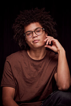 Studio portrait of young colored man with glasses on. Munich, Germany
