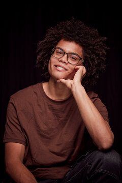 Studio portrait of young colored man with glasses on. Munich, Germany