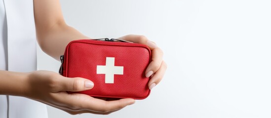 Female hands with first aid kit on white background.