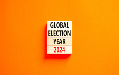Global election year 2024 symbol. Concept words Global election year 2024 on beautiful wooden block. Beautiful orange table orange background. Business Global election year 2024 concept. Copy space.