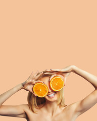 beautiful stylish girl holding orange smiling and looking at camera isolated on pastel background.