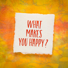 What makes you happy? A question handwritten on art paper, happiness and personal development concept.