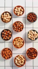Assorted nuts in bowls, a healthy snack variety on tiled backdrop