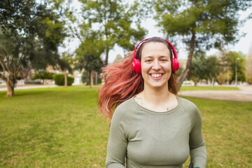 Joyful woman with red headphones