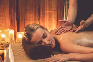 Poster Caucasian woman customer enjoying relaxing anti-stress spa massage and pampering with beauty skin recreation leisure in warm candle lighting ambient salon spa at luxury resort or hotel. Quiescent © Summit Art Creations