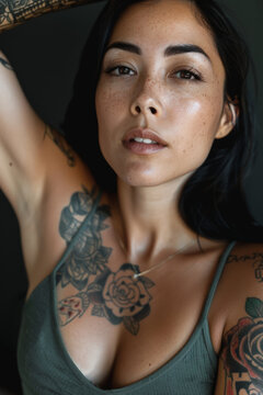 belle jeune femme en d&eacute;bardeur bras nu recouvert de tatouages