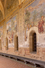 Cloister Santa Chiara, view of  corridor under arcades and decorated colorful frescoes, Naples,...