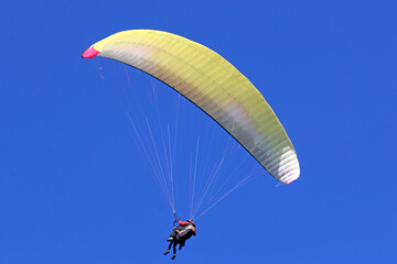 	
Tandem Paraglider flying in a blue sky