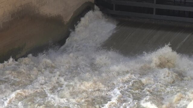 View of water rushing Video. Indus River Head Taunsa Barrage Gates. View of water rushing through the gates at a dam. flowing and splashing water in cold river. 4K Footage.