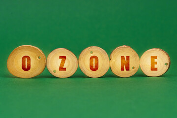 On a green background, wooden roundels with the inscription - Ozone