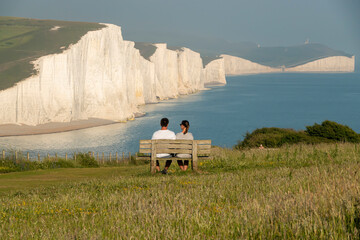 Young holidaymakers admire extraordinary seascape with beautiful chalk cliffs
