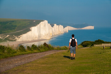 Young man walked to a viewpoint with a stunning view of the Seven Sisters cliffs