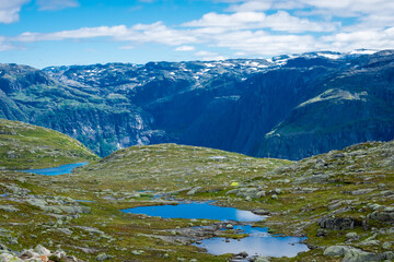 Fototapeta premium Beautiful blue ponds in the hiking trail of Trolltunga, Odda, Norway