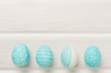 Blue easter eggs on wooden background, top view