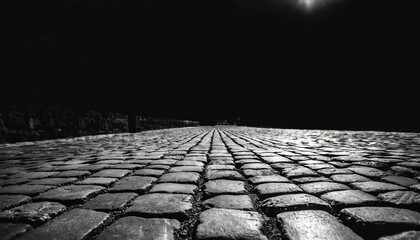 black background old cobblestone pavement in perspective abstract background black and white photo