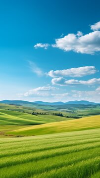 Green rolling hills under blue sky and white clouds
