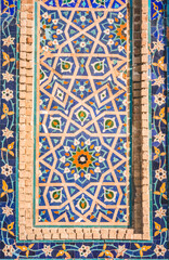 Facade of the Gur Emir mausoleum with mosaic brick walls in the ancient city of Samarkand in Uzbekistan, oriental architecture