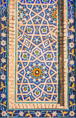 Facade of the Gur Emir mausoleum with mosaic brick walls in the ancient city of Samarkand in...