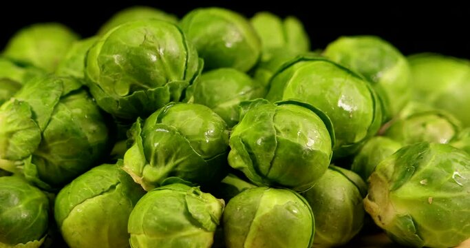 Brussels sprouts in extreme close up. A real green, delicious and wet winter vegetable on turning plate.