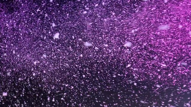 Artificial snow falling in the dark sky