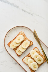 Peanut butter sandwich with fresh banana slices