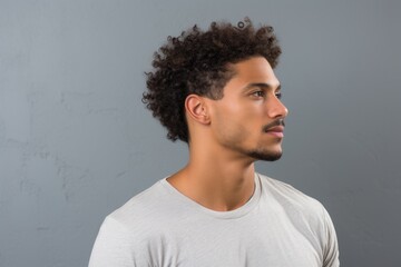 Side Portrait of Attractive African American Man Staring with Blank Background and Casual Attire.