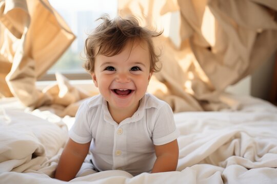 Portrait of laughing little girl lying on white bed looking up with funny face
