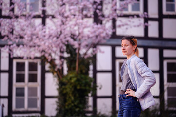 Serene Woman Enjoying Cherry Blossoms in Spring