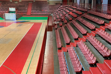 Fototapeta premium empty sports hall with wooden floor and bleachers