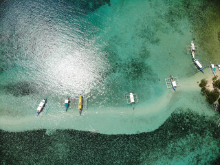 Wooden boats in blue lagoon aerial view