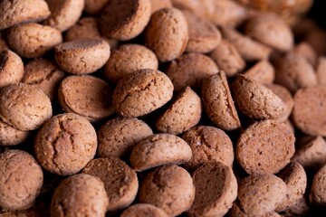 A portrait of a lot of delicious traditional dutch snacks called pepernoten or pepernuts. The gingerbread treat is a tradition during the holidays and sinterklaas or saint nicholas.