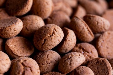 A tasty food portrait of a pile of delicious traditional dutch snacks called pepernoten or pepernuts. The gingerbread treat is a tradition during the holidays and sinterklaas or saint nicholas.