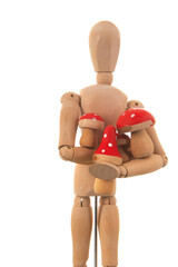 Wooden mannequin with red mushrooms