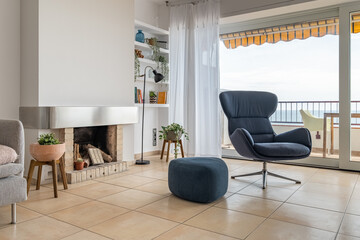 Living room with fireplace armchairs and terrace in apartment
