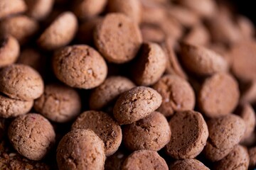A delicious portrait of a pile of tasty traditional dutch snacks called pepernoten or peper nuts....