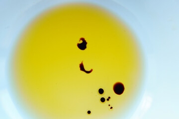 Drops of balsamic vinegar in a bowl of olive oil