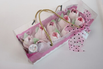 Gift box with pink tulips and bows on a white background. Tulips from marshmallows. Zephyr flowers. Homemade zephyr.