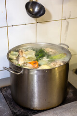 Cook cooks chicken broth in a saucepan