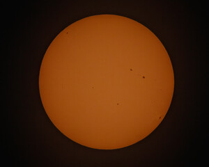 photo of the sun with sunspots against a dark background