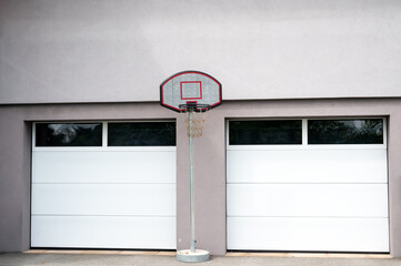 basketball basket in an outdoor court near garage. Backyard Sport concept. 