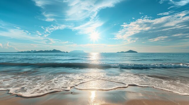 A picturesque sea beach landscape under a blue sky, with golden sand and the sun casting its warm glow
