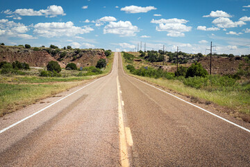 Asphalt road through the desolate empty New Mexico landscape along Historic US Route 66, USA