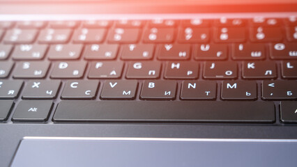 Laptop keyboard with Russian layout, Spacebar close-up, close-up tinted image.