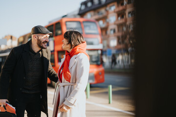 Dynamic outdoor meeting between business colleagues in an urban setting, highlighting teamwork and strategy with a vibrant city backdrop.