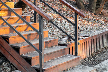 empty wooden staircase in the park in late autumn