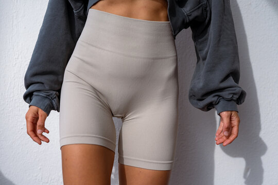 Fitness woman. beautiful athletic figure of a girl in leggings and a sweatshirt. athletic girl body