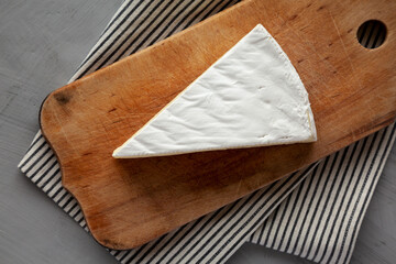 Organic Brie Cheese on a wooden board, top view. Flat lay, overhead, from above.