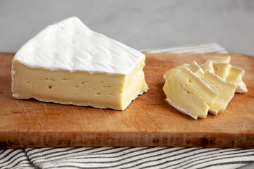 Fototapeta na wymiar Organic Brie Cheese on a wooden board, side view.