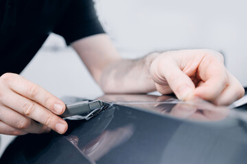 Process of pasting of car with protective vinyl film from gravel chips and scratches. Transparent protection for paint